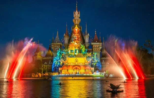 Illuminated castle with colorful lights and fountains at night, VinWonders Phu Quoc